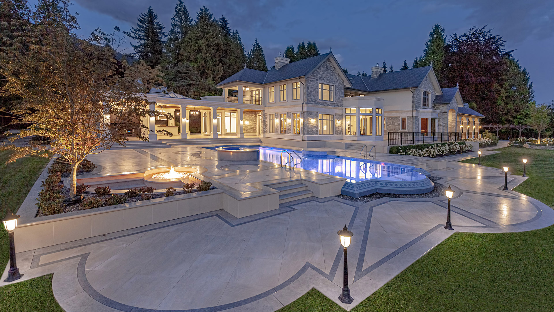 Altamont's Muse pool at twilight with LED lighting and fire feature in West Vancouver