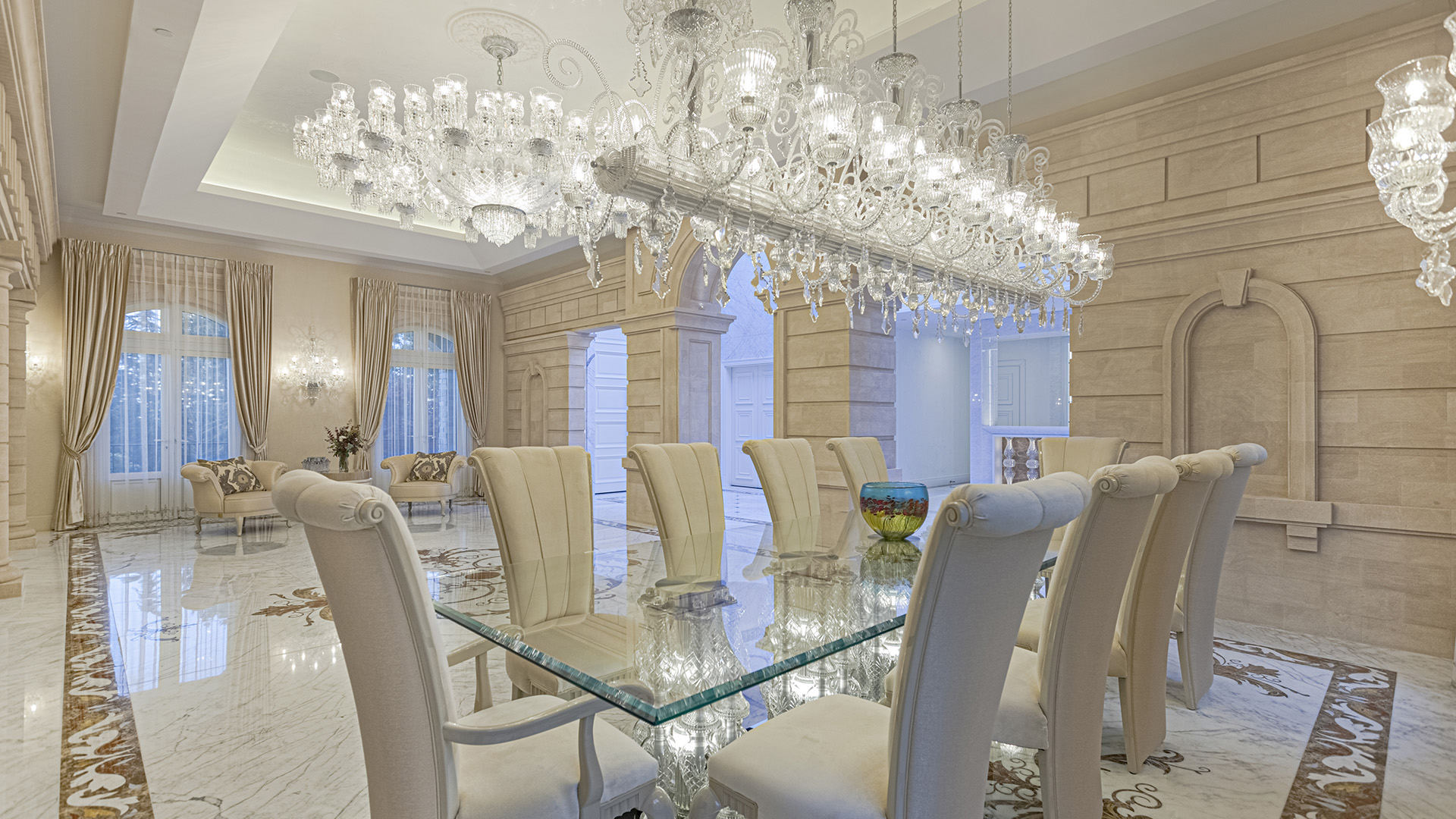 Altamont's Muse formal dining room with crystal chandelier and glass table in West Vancouver