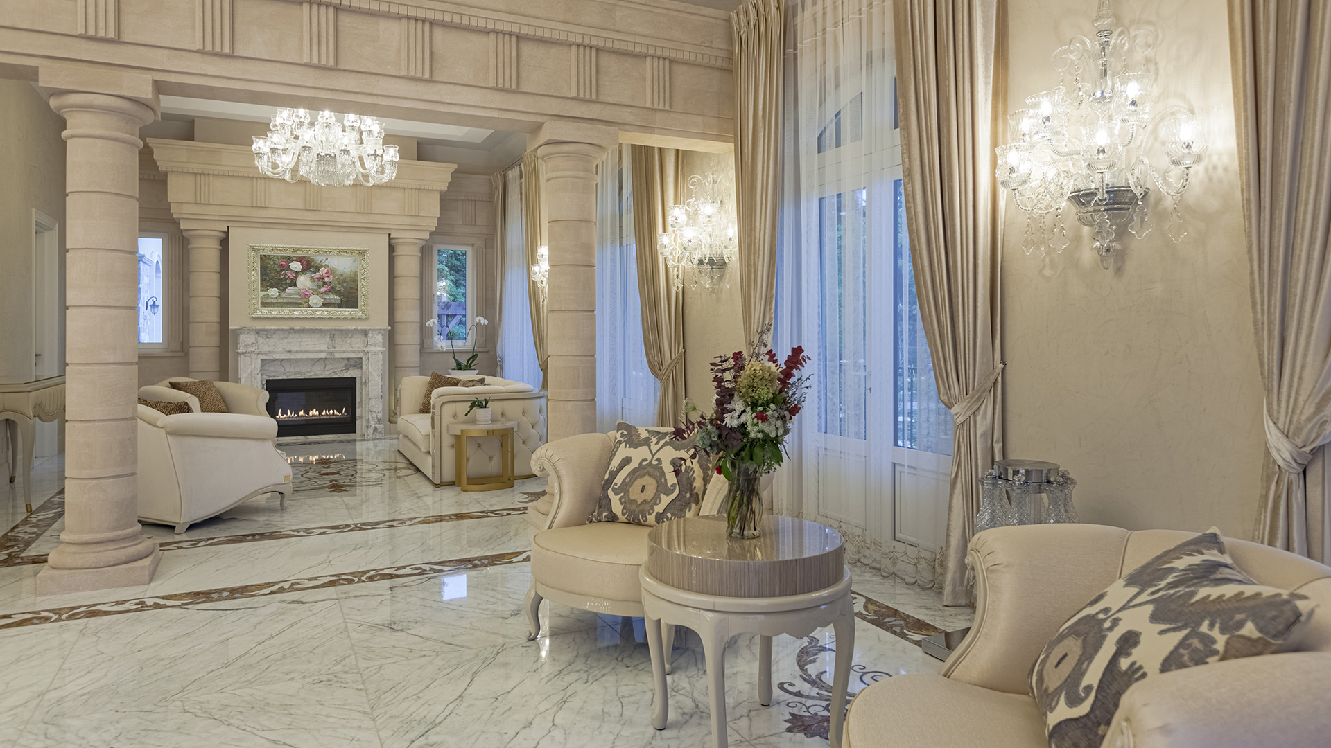 Altamont's Muse grand salon with columns, fireplace, and inlaid marble floors in West Vancouver