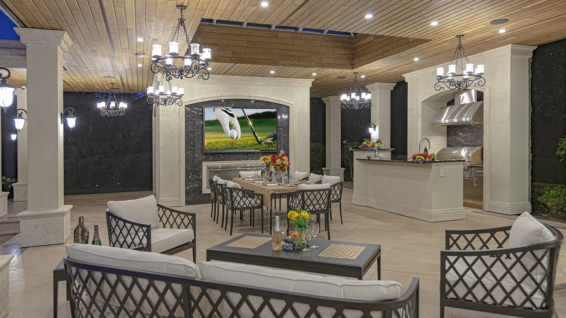 Altamont's Muse outdoor kitchen pavilion with TV, chandeliers, and dining area in West Vancouver