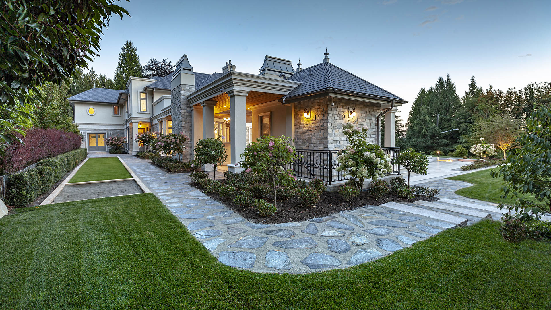 Altamont's Muse front entrance and gatehouse with flagstone pathways in West Vancouver