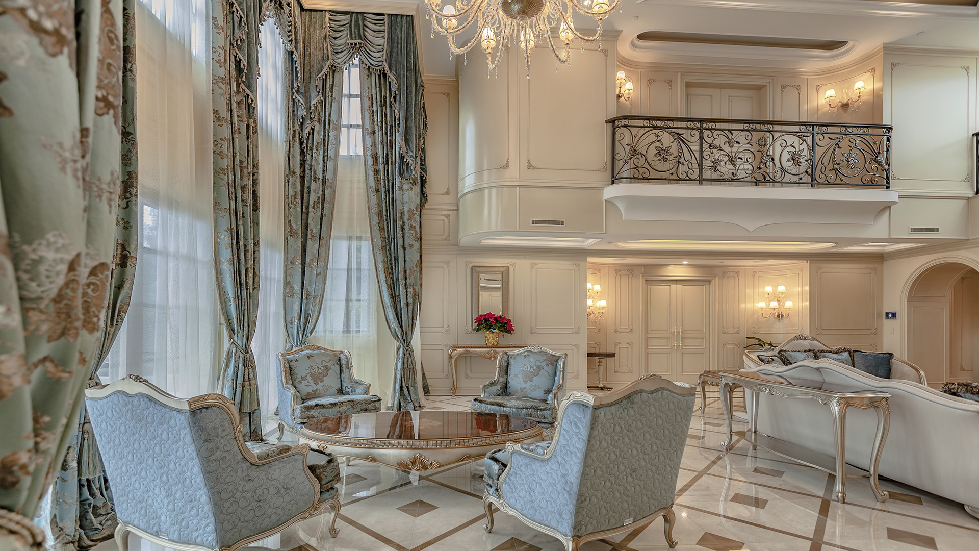 Ambleside Palace living room with wrought iron mezzanine balcony and French Provincial seating in West Vancouver