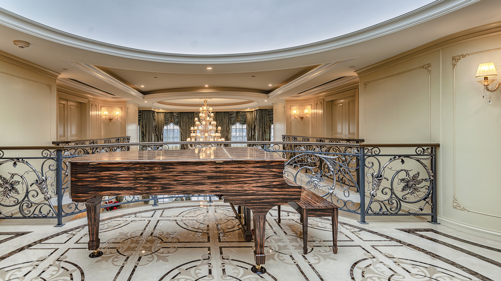 Ambleside Palace grand piano on upper rotunda with ornamental iron railing and inlaid marble floor in West Vancouver