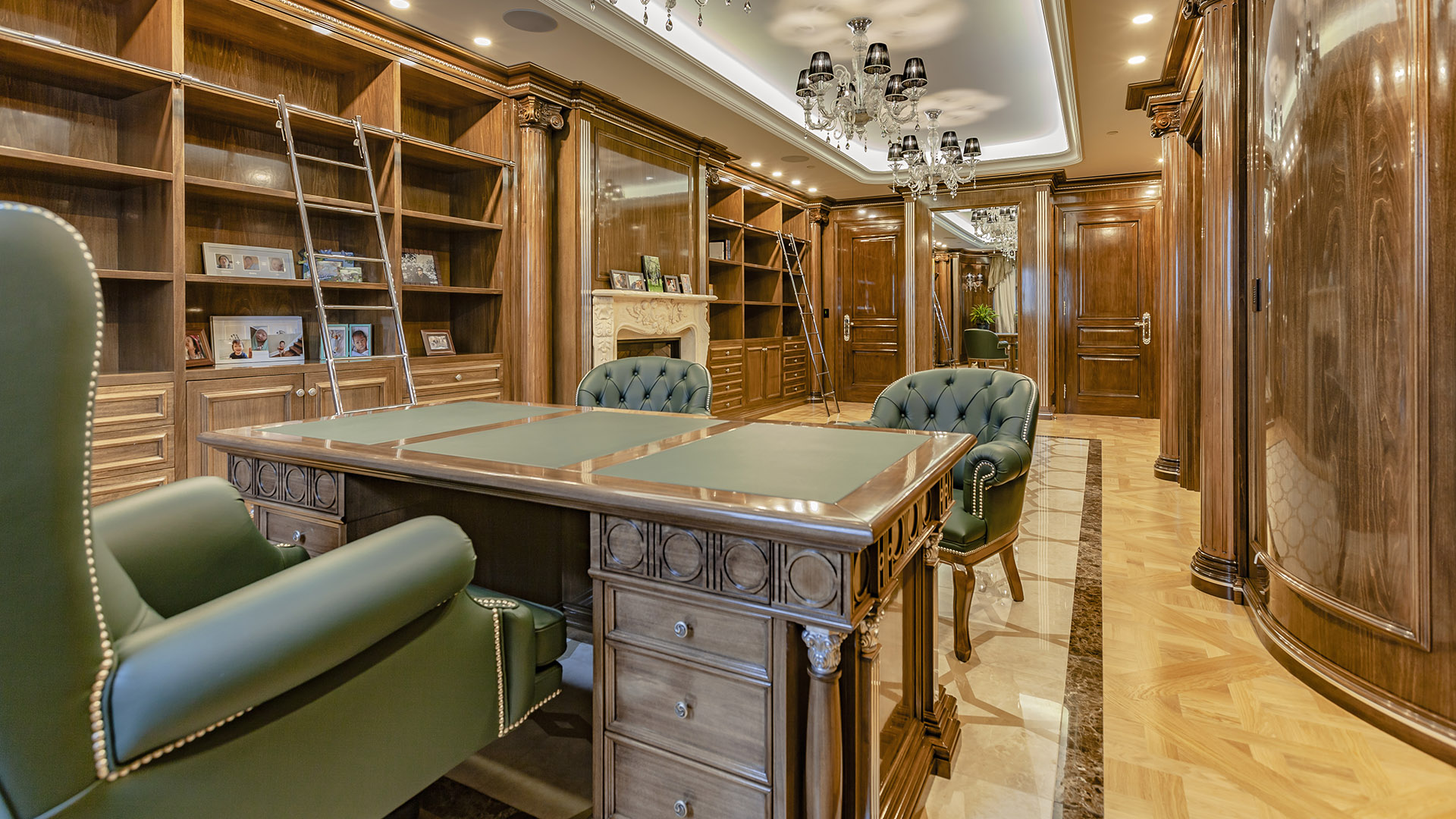 Ambleside Palace library wide view with dual brass ladders and Murano glass chandelier in West Vancouver
