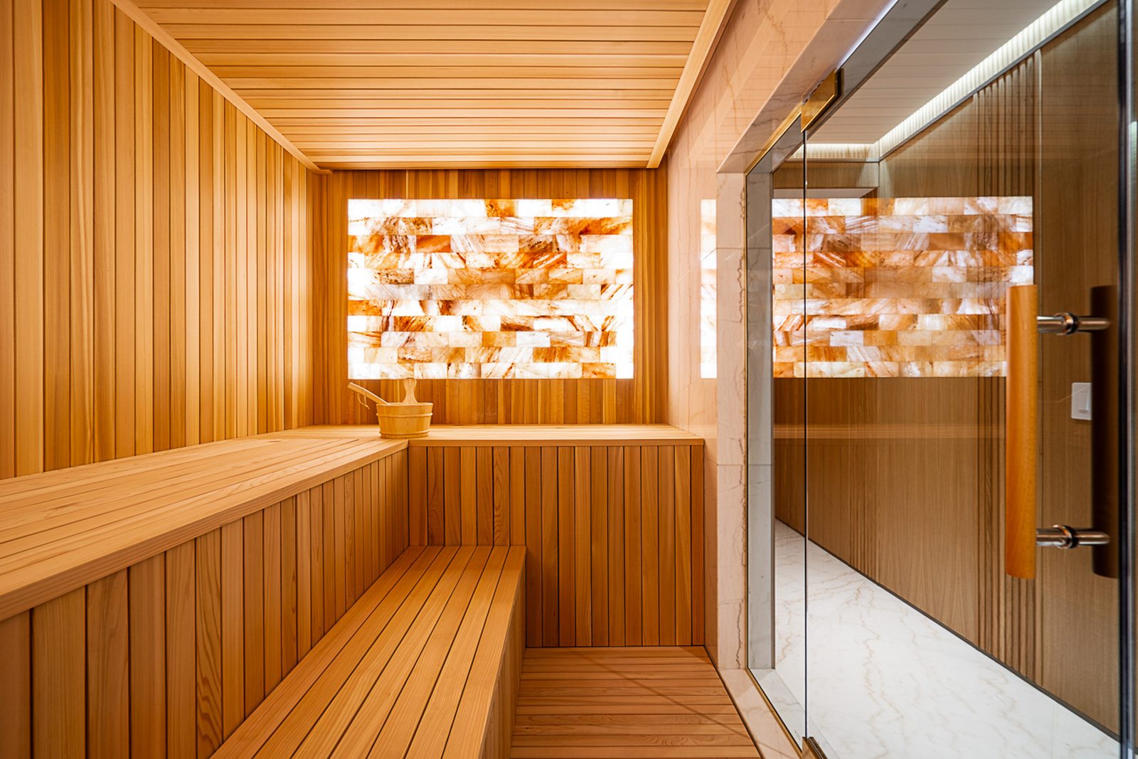 Spa corridor with backlit Himalayan salt wall terrazzo accent and warm walnut ceiling West Vancouver estate