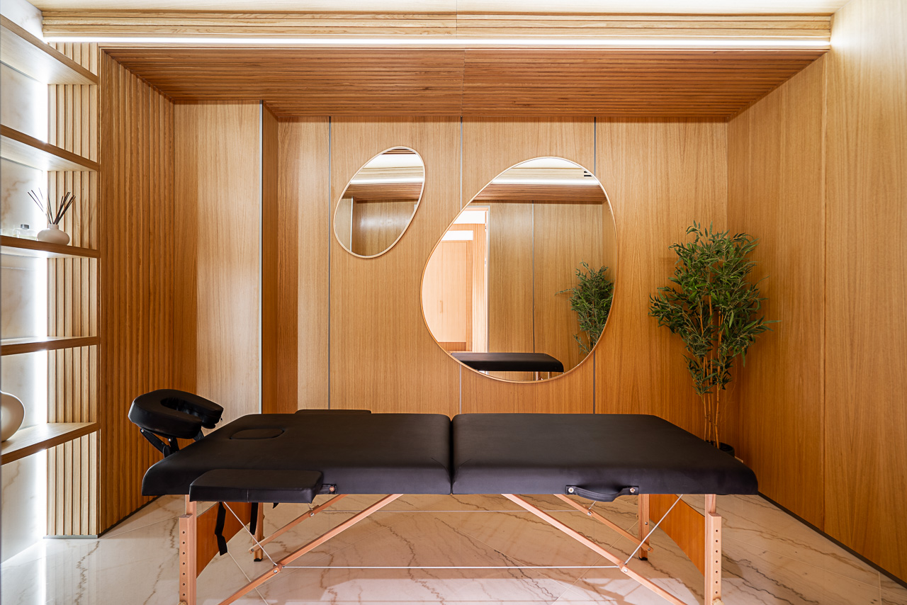 Dedicated spa massage room with wood panelling organic mirrors and marble floor The Butterfly West Vancouver