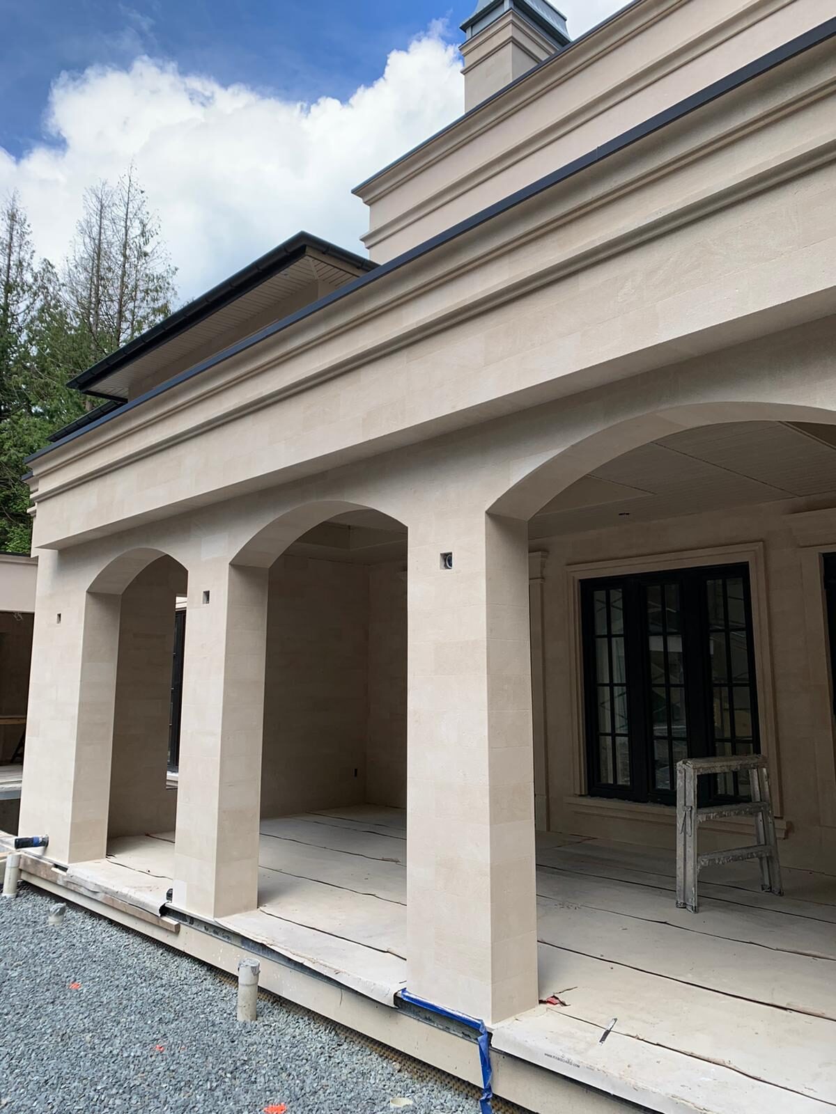 Five-car garage with stone arcade arches