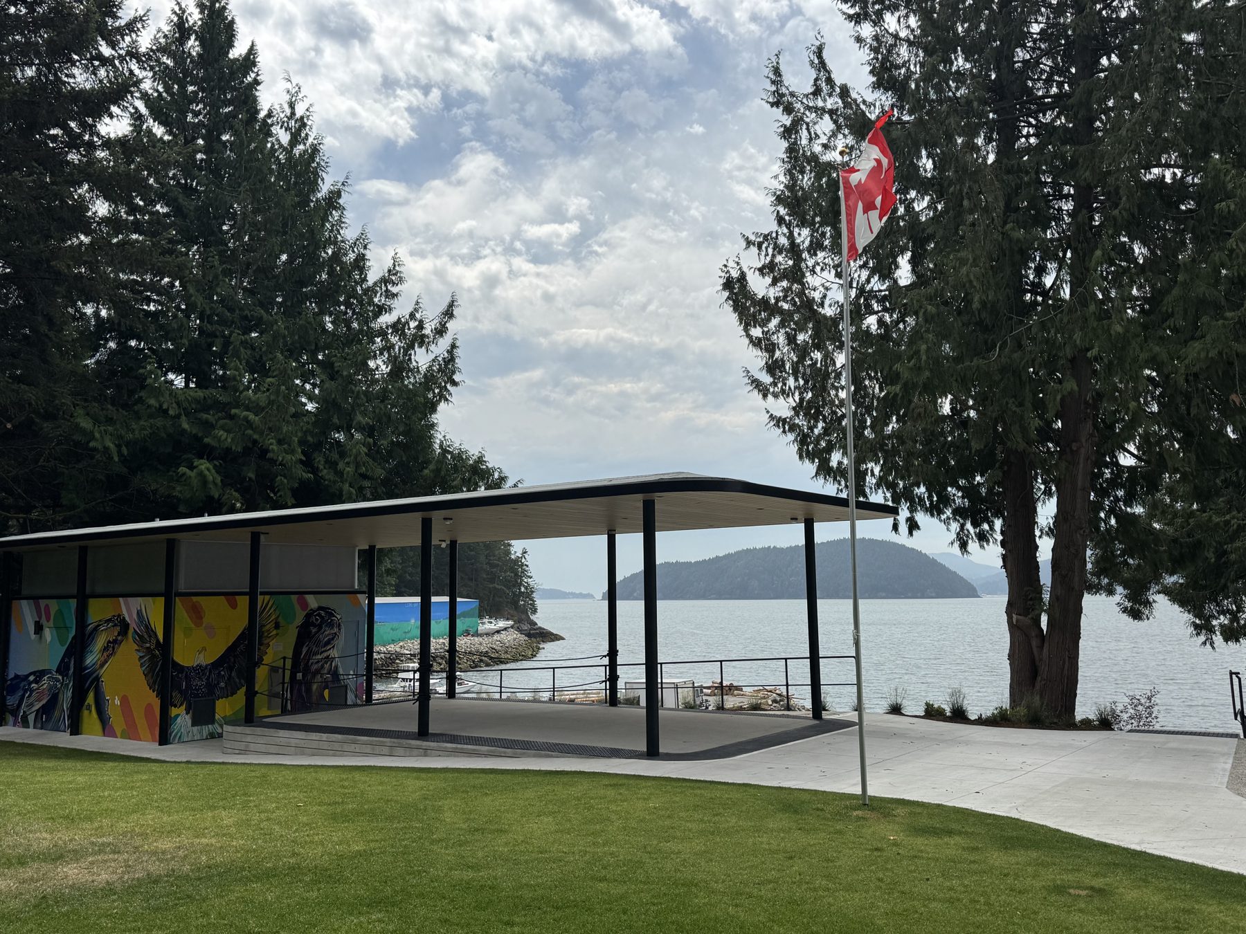 Completed Lions Bay Beach Park pavilion with steel canopy, public art mural wall and Howe Sound views, built by Eurohouse Construction