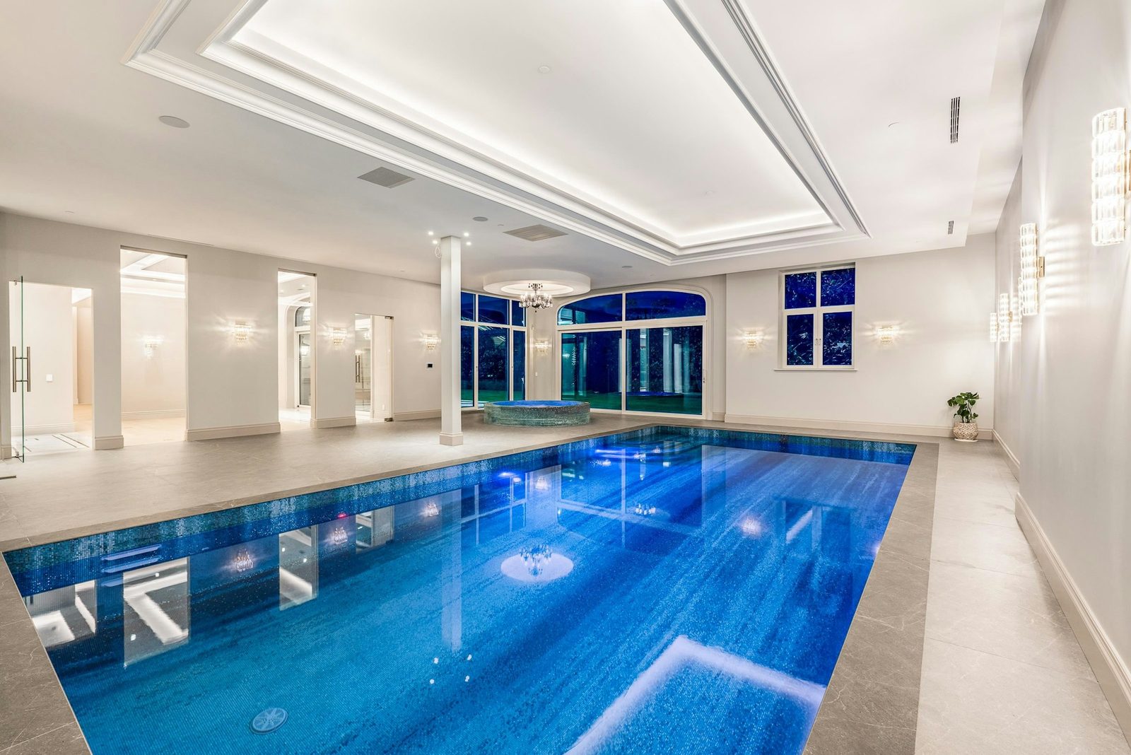 Indoor swimming pool with tray ceiling and columns at Montbeau Eyremount luxury estate West Vancouver