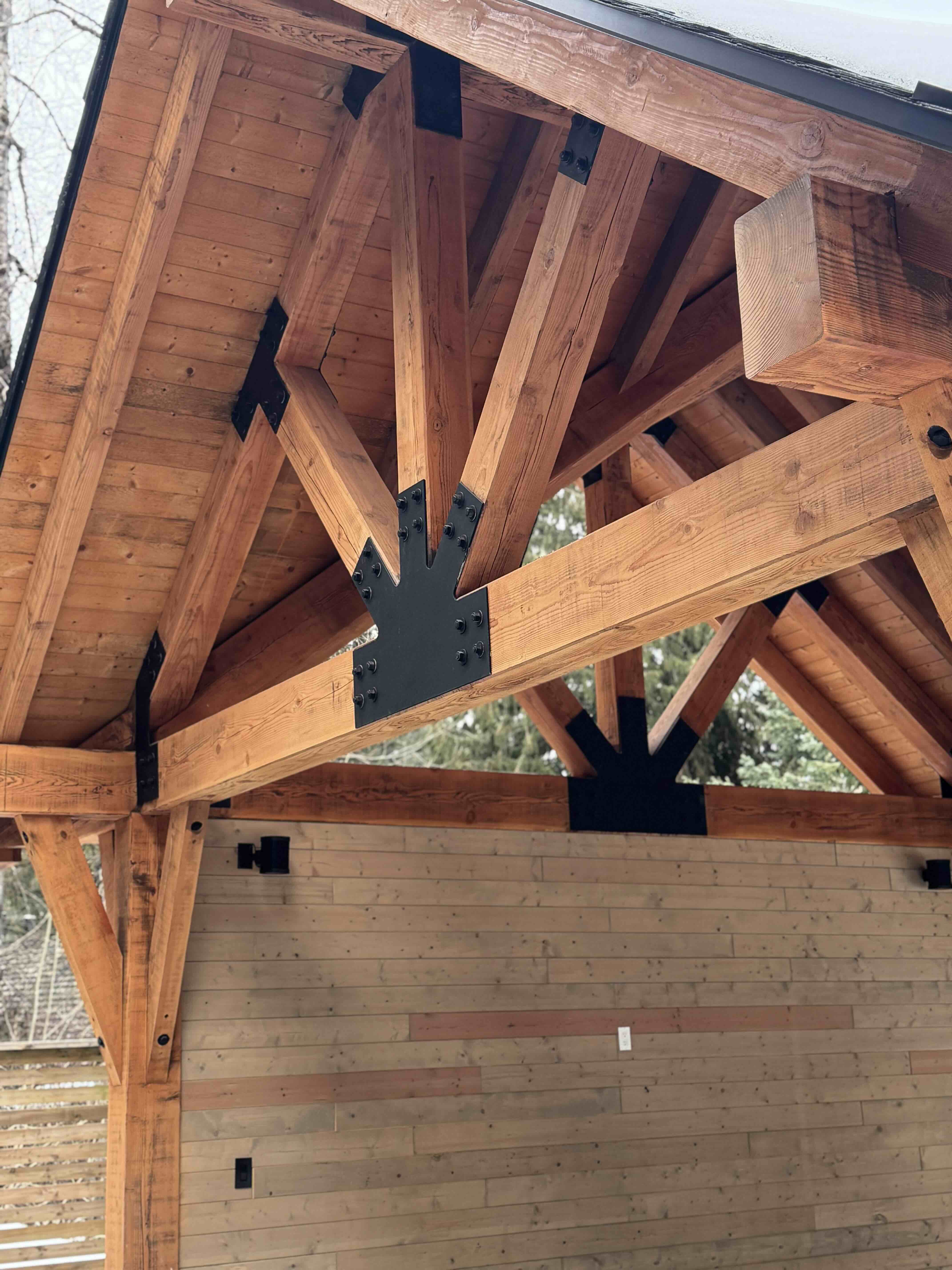 Timber gazebo roofline detail with bolted steel connections and cedar shingle roof at Rainbow in Whistler by Eurohouse Construction