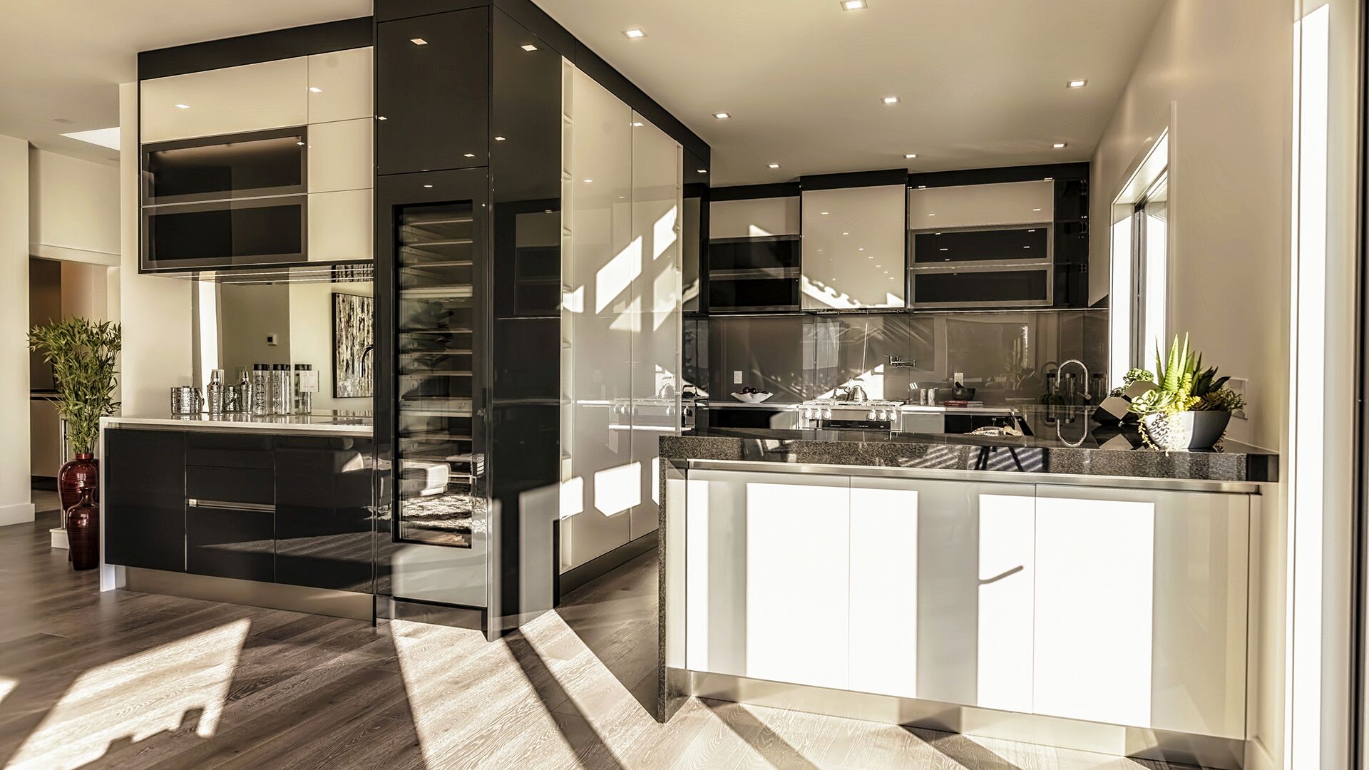 Close-up of Italian gloss lacquer cabinetry with mirrored reflections and granite countertops in West Vancouver kitchen by Eurohouse Construction