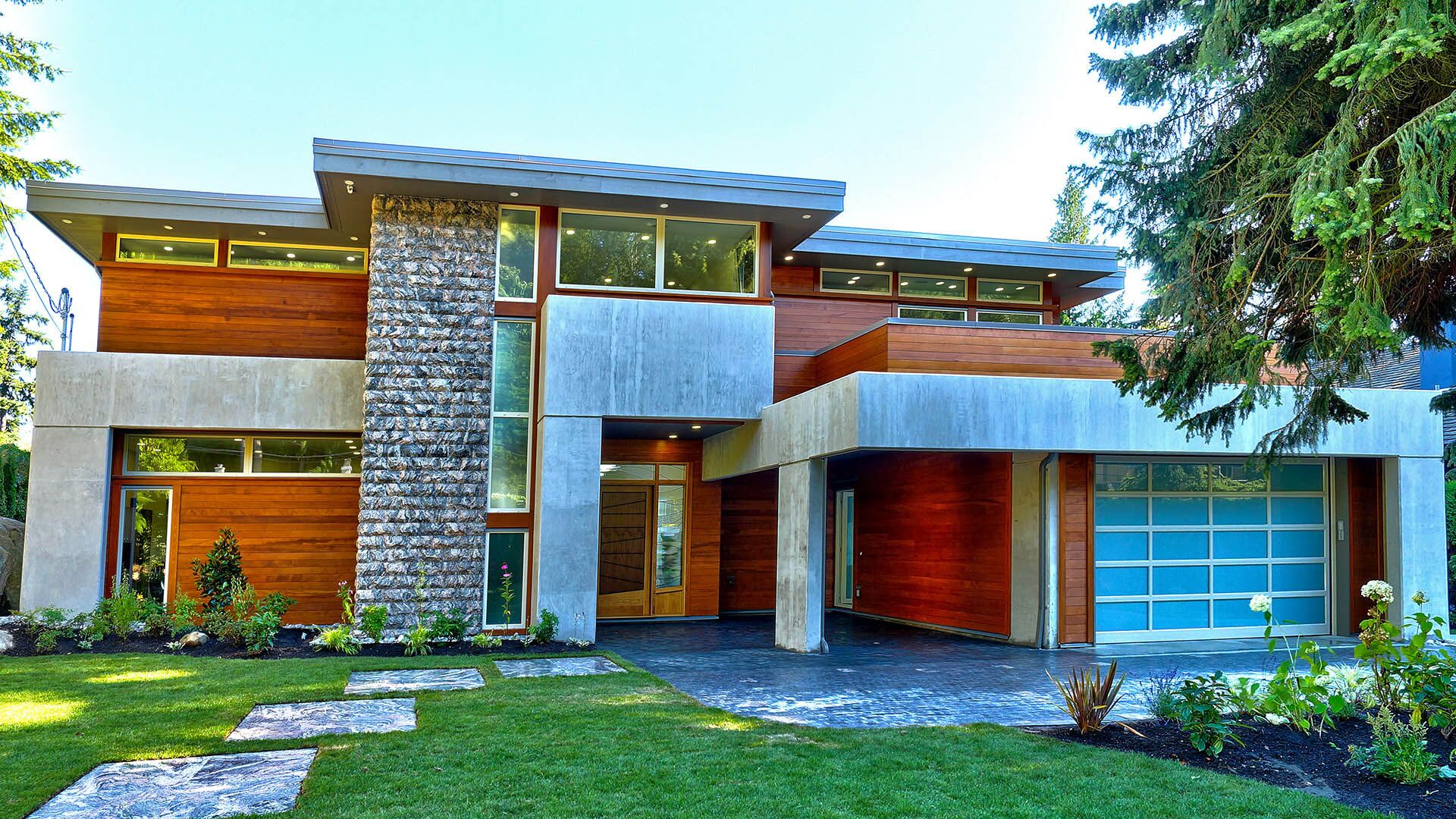 Rose Crescent luxury custom home front elevation with natural stone, western red cedar, and contemporary architecture in Sandy Cove, West Vancouver — developed by Eurohouse Construction