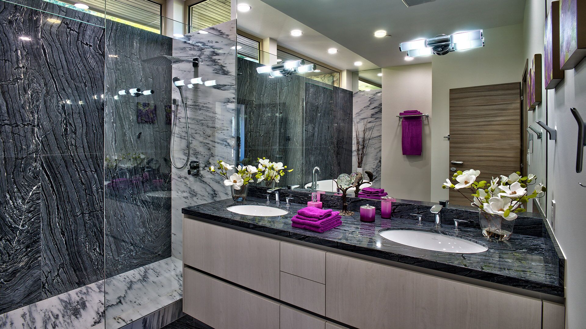 Master ensuite with dramatic veined marble slab walls and frameless rain shower at Rose Crescent Sandy Cove West Vancouver by Eurohouse Construction