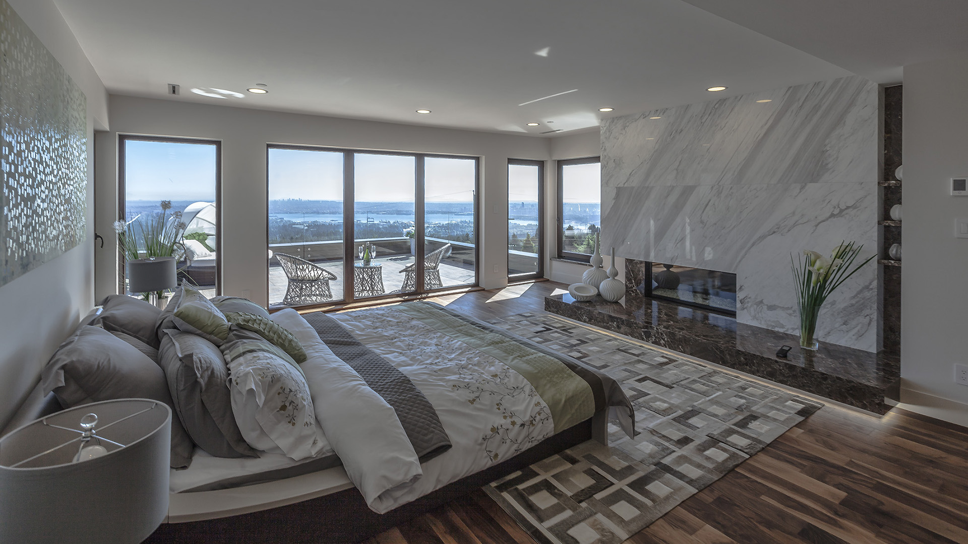 Master bedroom with exquisite marble fireplace walnut flooring private deck and panoramic Lions Gate Bridge views West Coast Contemporary British Properties West Vancouver