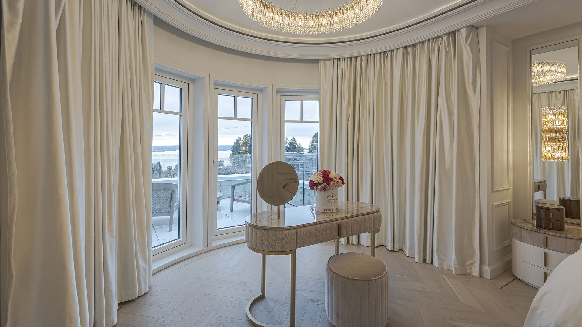 Master bedroom vanity area with curved bay window ocean views and crystal chandelier West Vancouver meets Manhattan Eurohouse