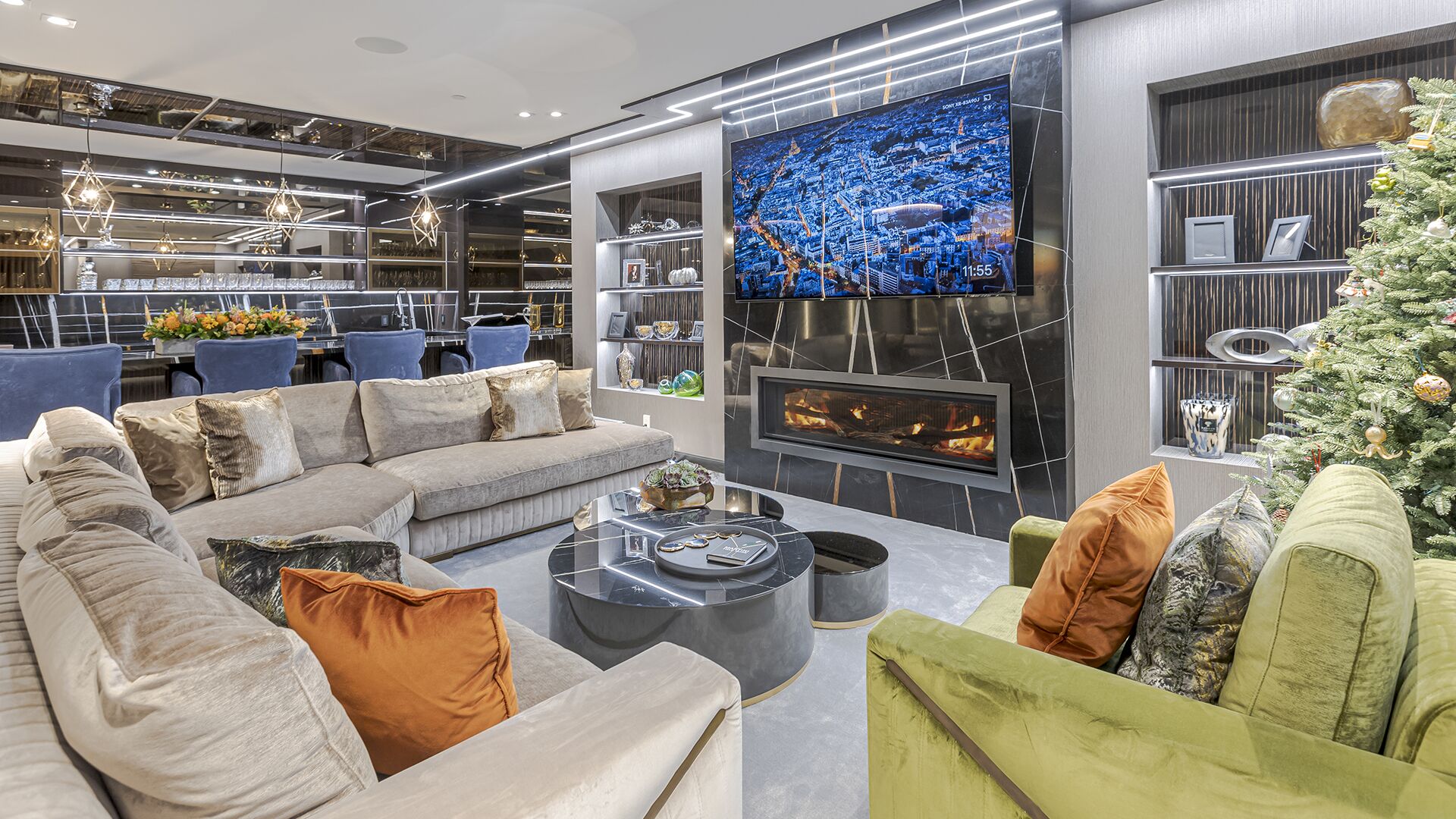 Entertainment lounge with linear fireplace built-in shelving large TV and velvet seating lower level West Vancouver luxury home Eurohouse Construction