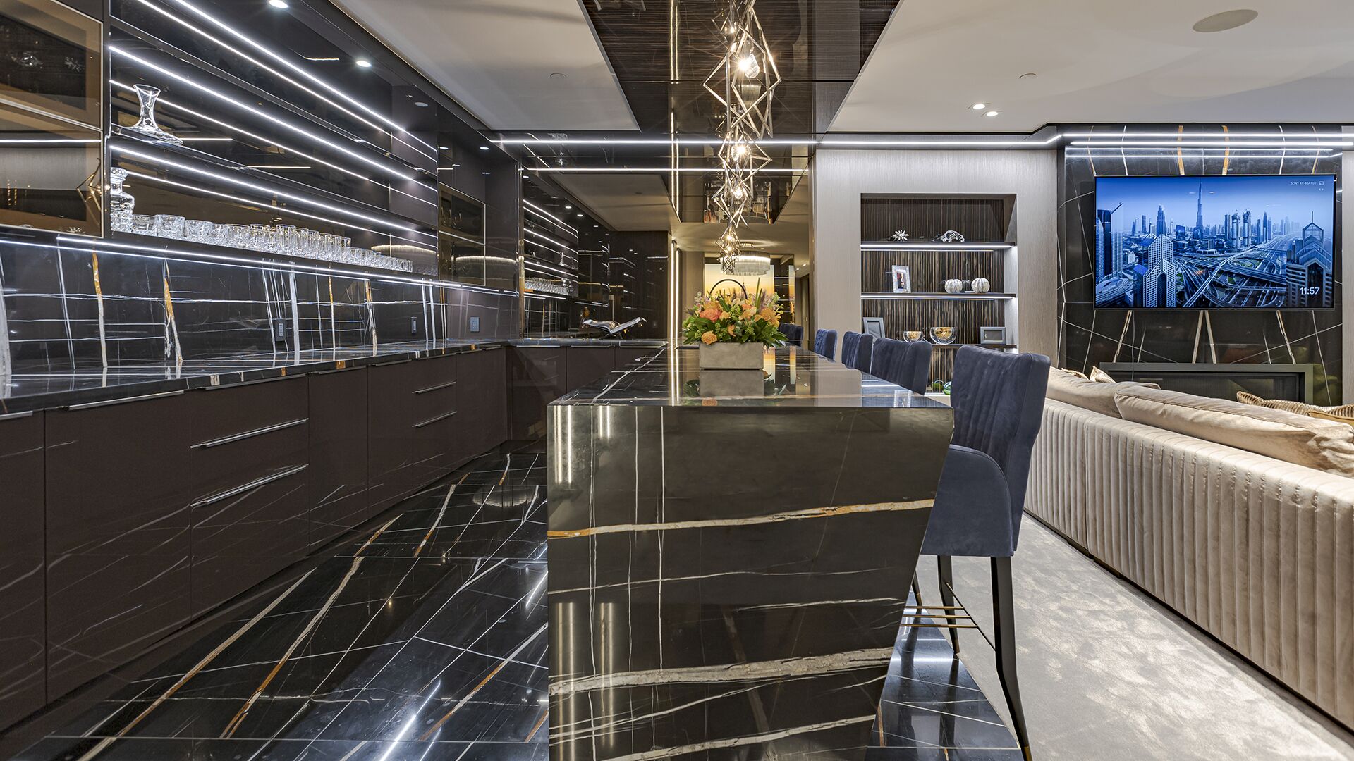 Manhattan-inspired bar with veined black marble mirrored ceiling crystal glassware and geometric pendants luxury West Vancouver home Eurohouse