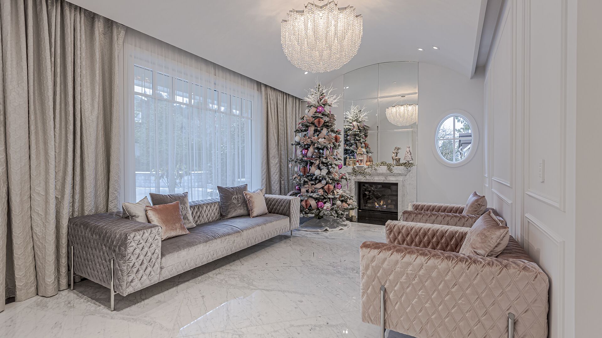Living room with velvet furniture marble fireplace crystal chandelier and floor-to-ceiling windows West Vancouver luxury home Eurohouse