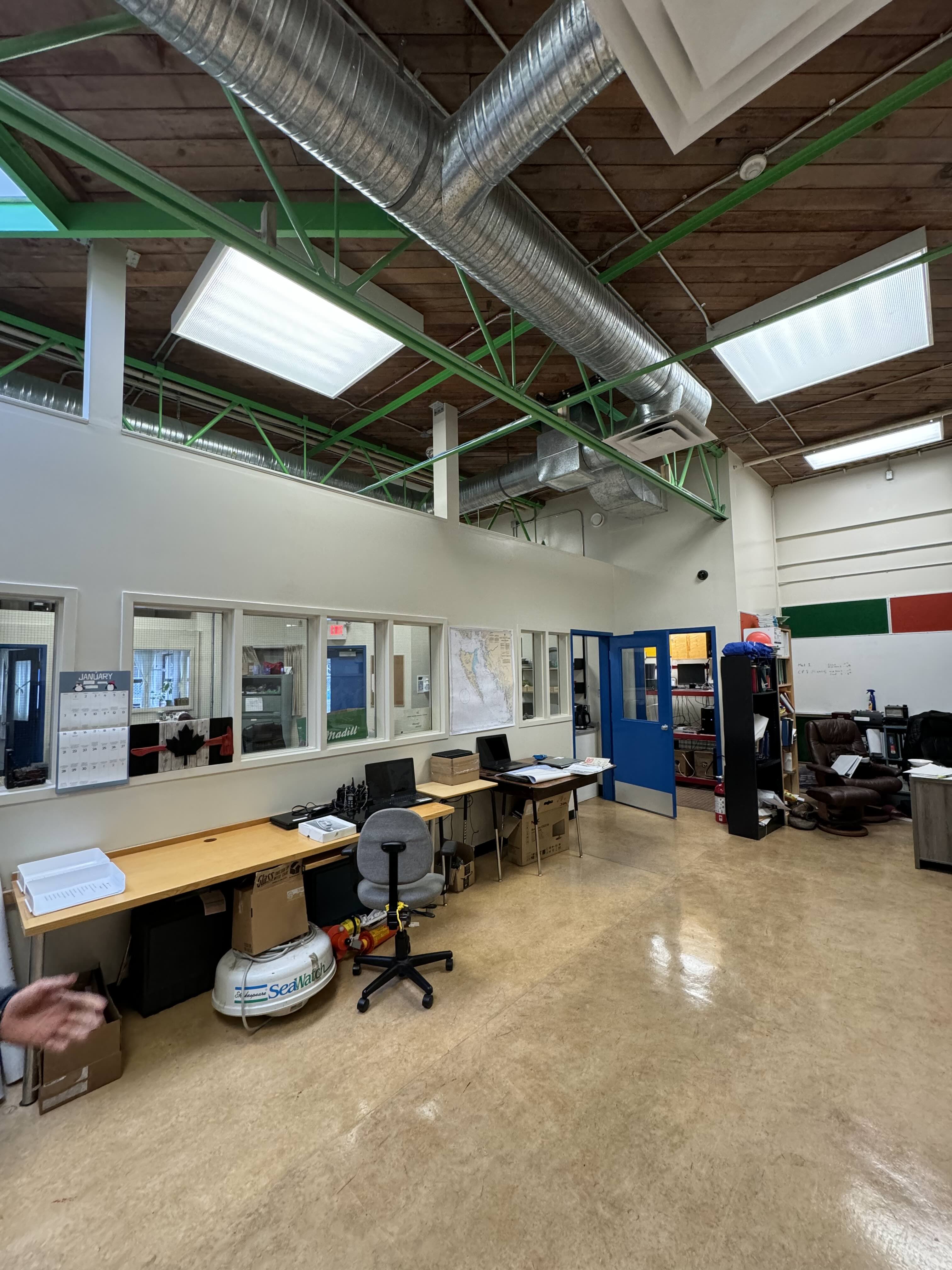 Renovated classroom and workspace with exposed timber ceiling and new ductwork at Western Maritime Institute