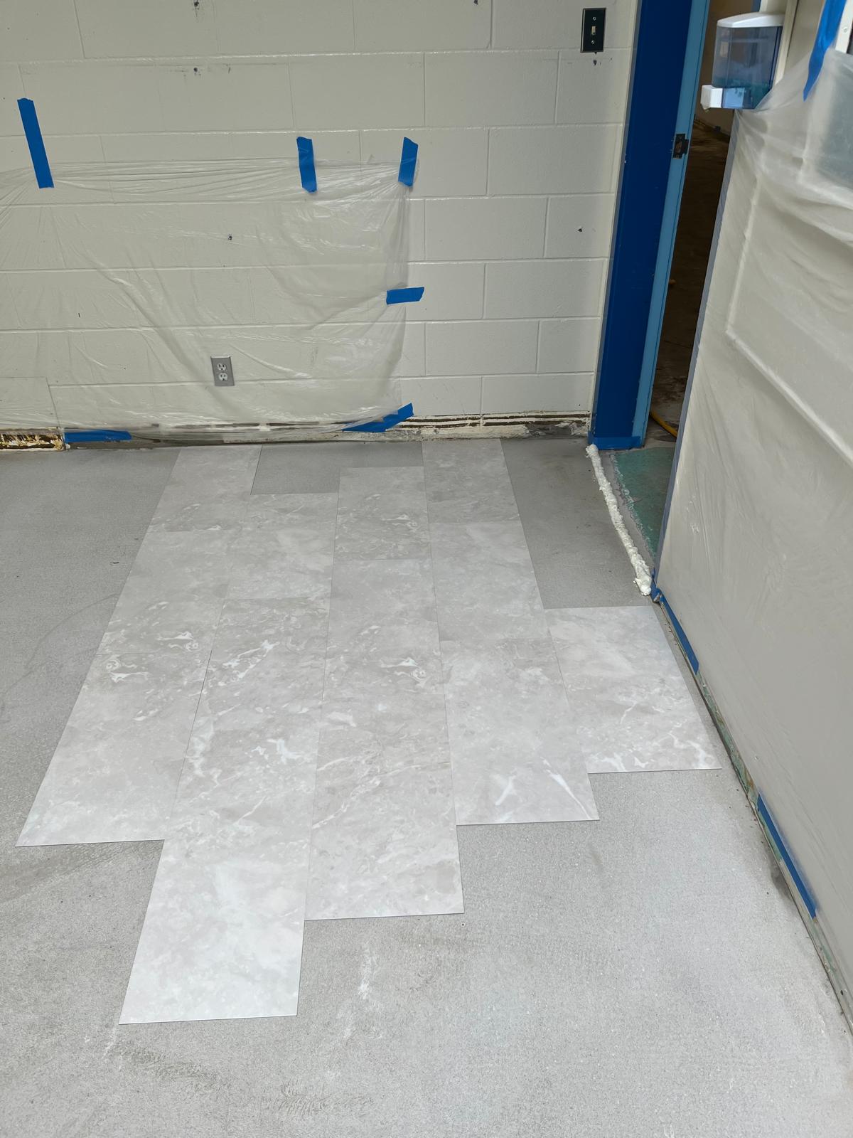 New commercial flooring being installed over old substrate at Western Maritime Institute